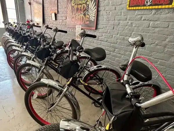 Black and silver cruiser bicycles lined up for rental inside the Bike Rental New Orleans French Quarter shop